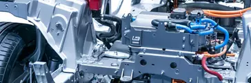 Chassis of the electric car with powertrain and power connections closeup.