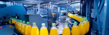 Beverage factory interior. Conveyor with bottles for juice or water. Modern equipments
