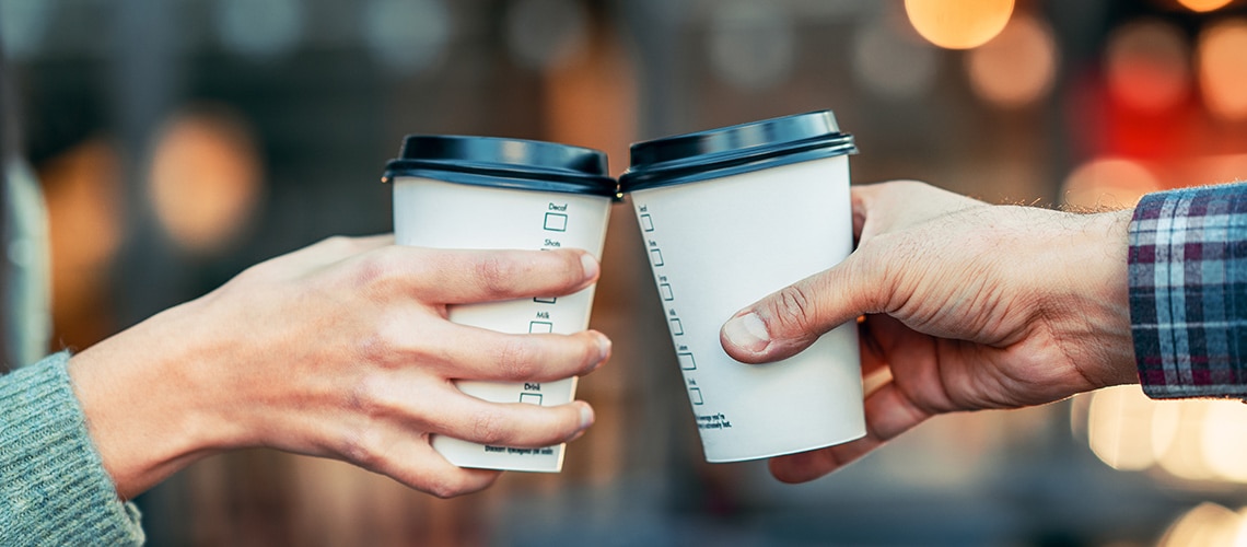 A toast with two paper coffee cups A toast with two paper coffee cups