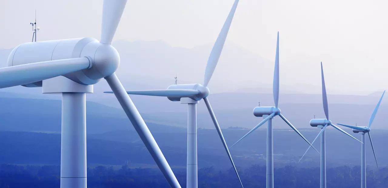 Wind turbine farm against distant mountains